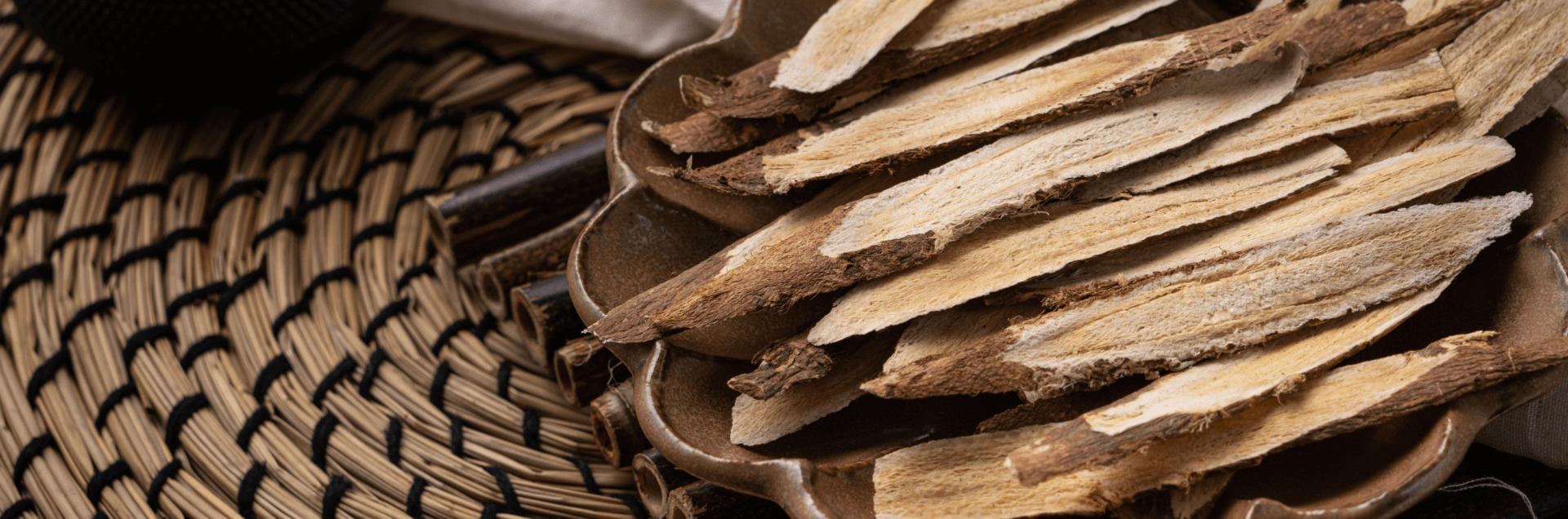 Astragalus Root Benefits - astragalus root pieces in a bowl with a teapot