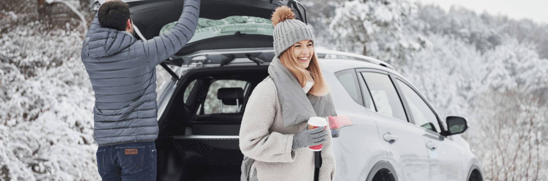 TCM for motion sickness - woman and man getting out of car in snowy area